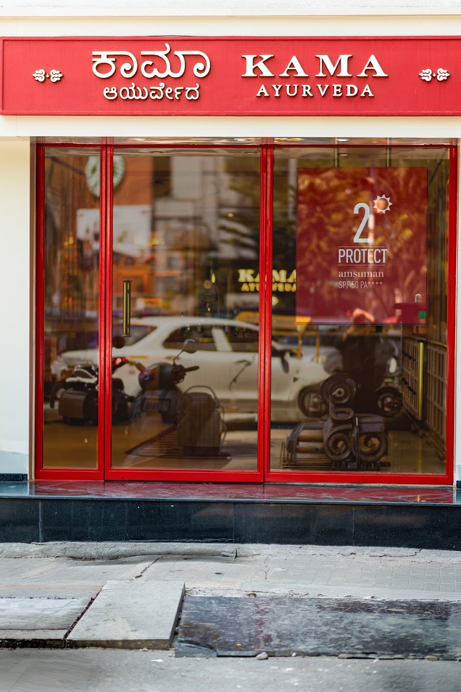 Kama Ayurveda store interior, heritage red, brass and arches, photo 11