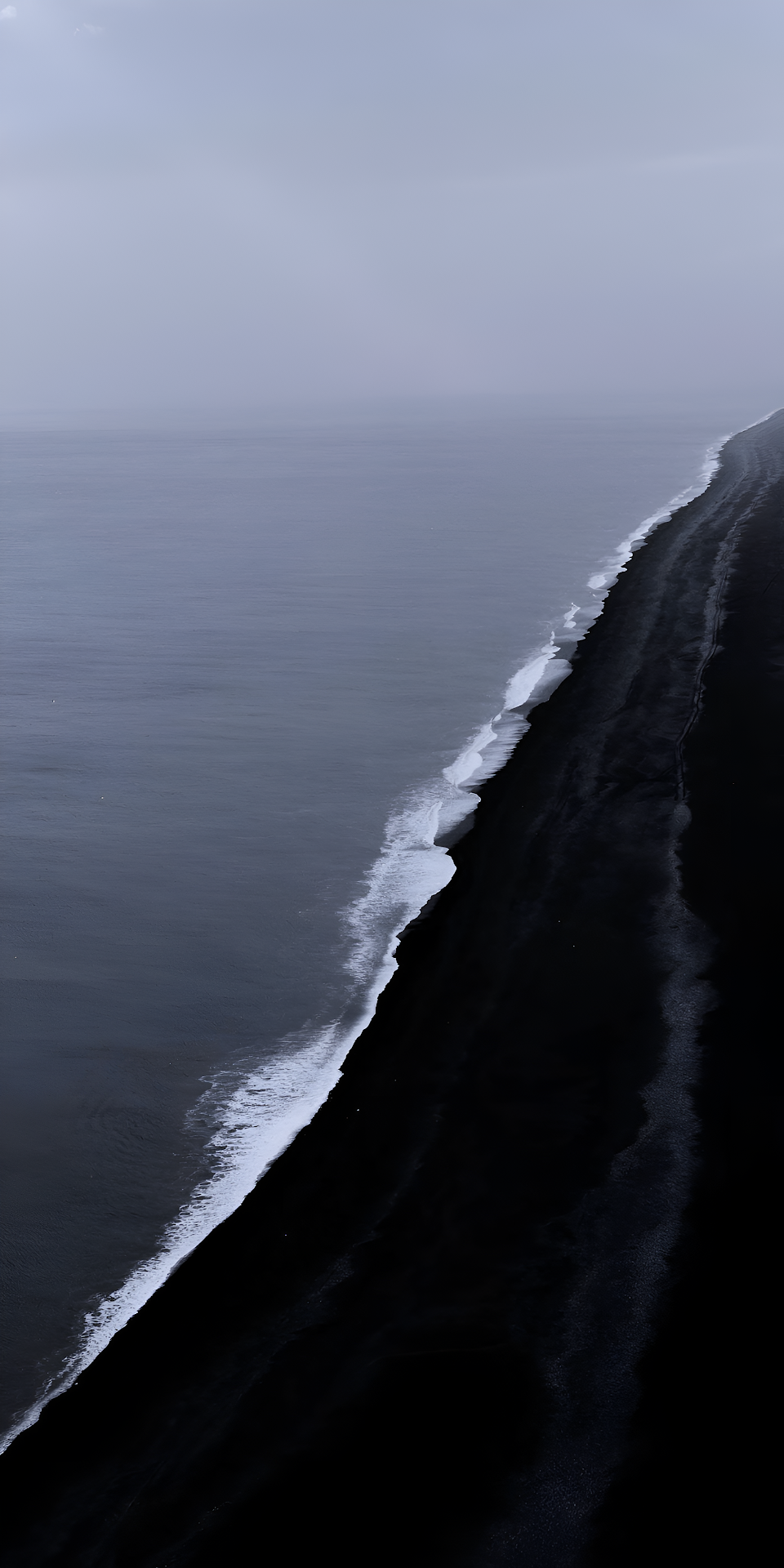 Stark Black Sand Beach and Moody Ocean Coastline View - Free 4K mobile Wallpaper