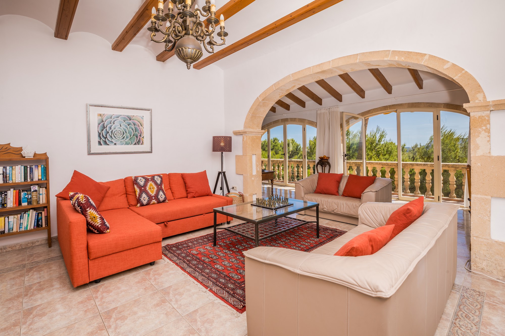 Main lounge with orange sofas and arched windows