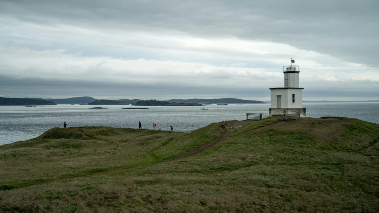Historic coastal lighthouse on the grassy bluff overlooking the Salish Sea on San Juan Island