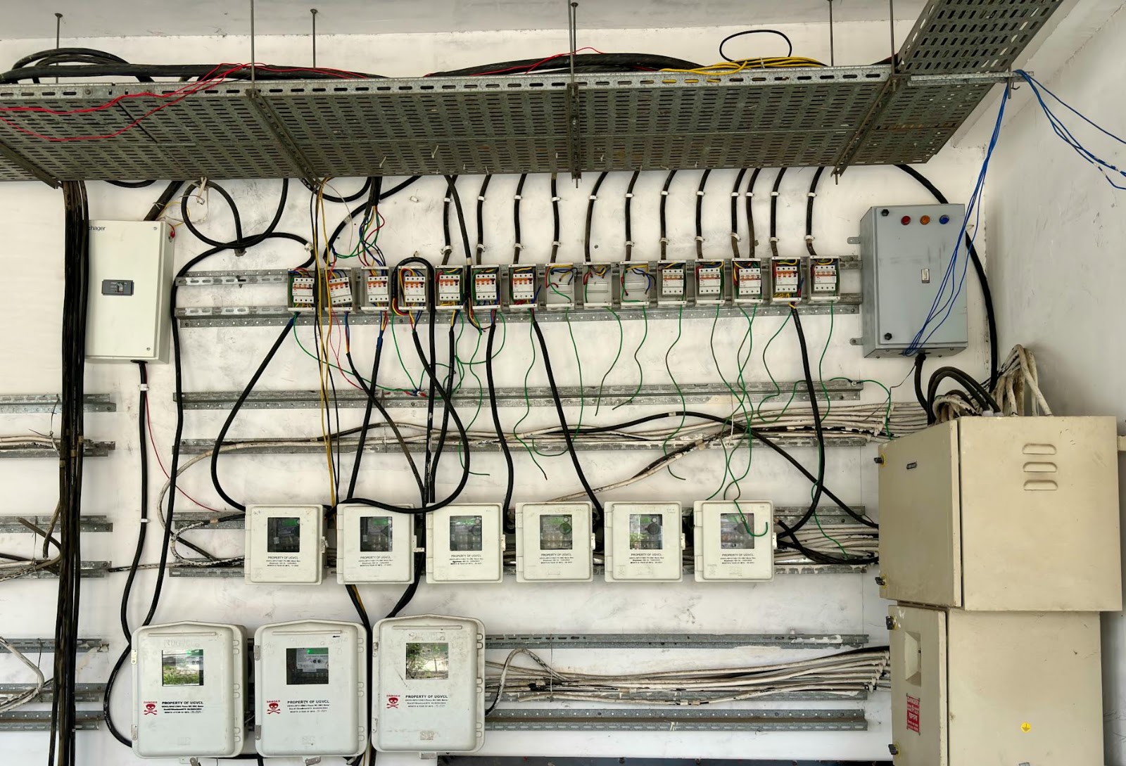 Organized but complex smart home wiring behind a control panel, highlighting the hidden infrastructure of a smart home.