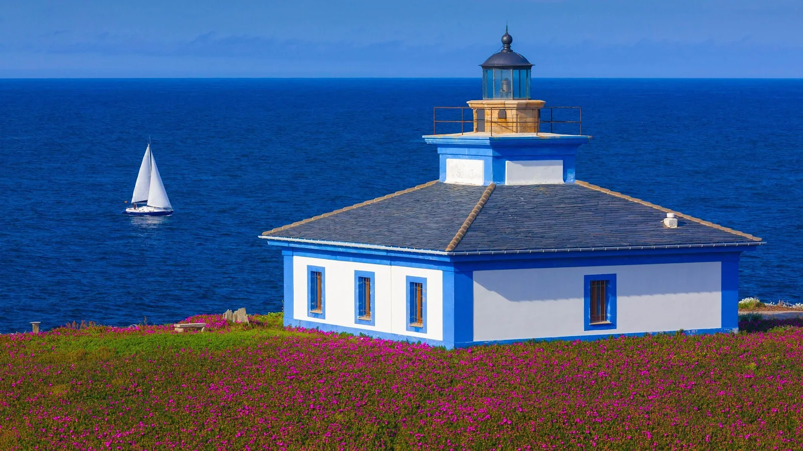 Coastal Lighthouse Over Deep Blue Sea - Vibrant Landscape Photography 4K Wallpaper (3840x2160)