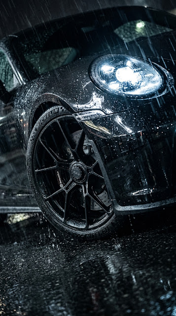 Close-up of a Black BMW Car parked in Heavy Rain - Free mobile Wallpaper
