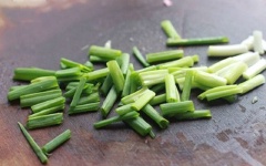 Cá nục làm sạch, bỏ ruột, cắt đôi theo đường xéo giữa thân cá. Hành lá cắt khúc.