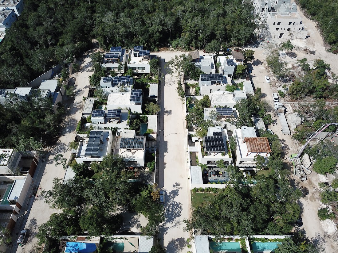 Aerial view of the Florafauna neighbourhood, its homes, pools and tree canopy