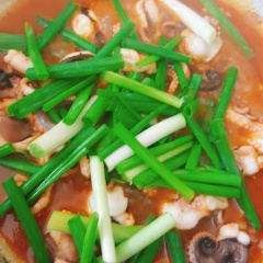 Đun nóng 2 muỗng canh dầu ăn, cho tỏi vào phi thơm. Tỏi vừa vàng thì cho bạch tuộc vào đảo nhanh tay ở lửa lớn. Hòa 1/2 chén nước với 1.5 muỗng canh tương ớt hàn quốc. Bạch tuộc vừa săn thì cho tương ớt vào.