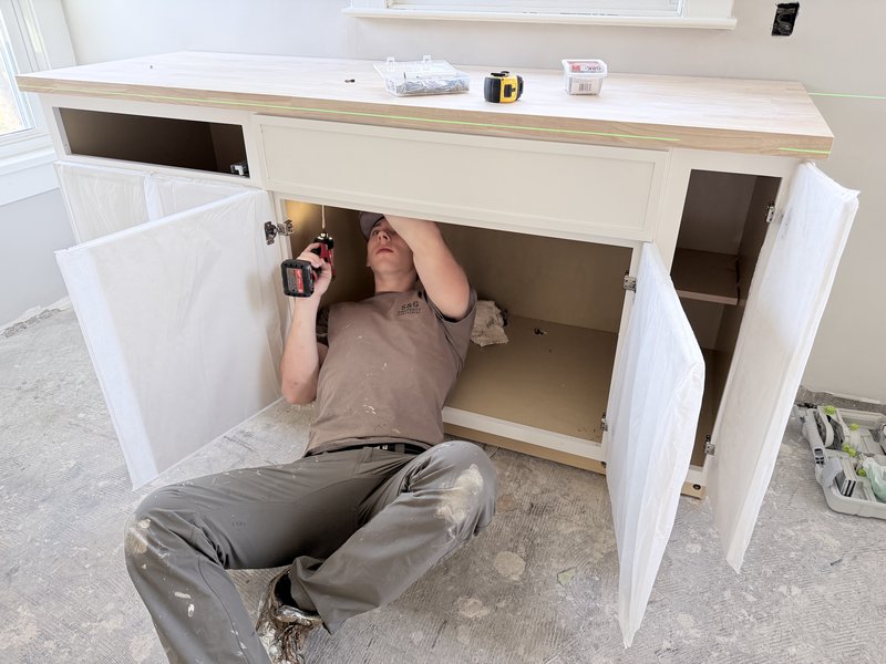 Gavin Dies installing cabinets in a Eureka IL home