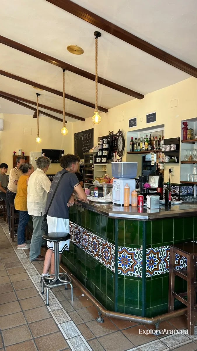 Green-tiled bar and traditional interior of Bar Restaurante Los Olivos in Aracena.