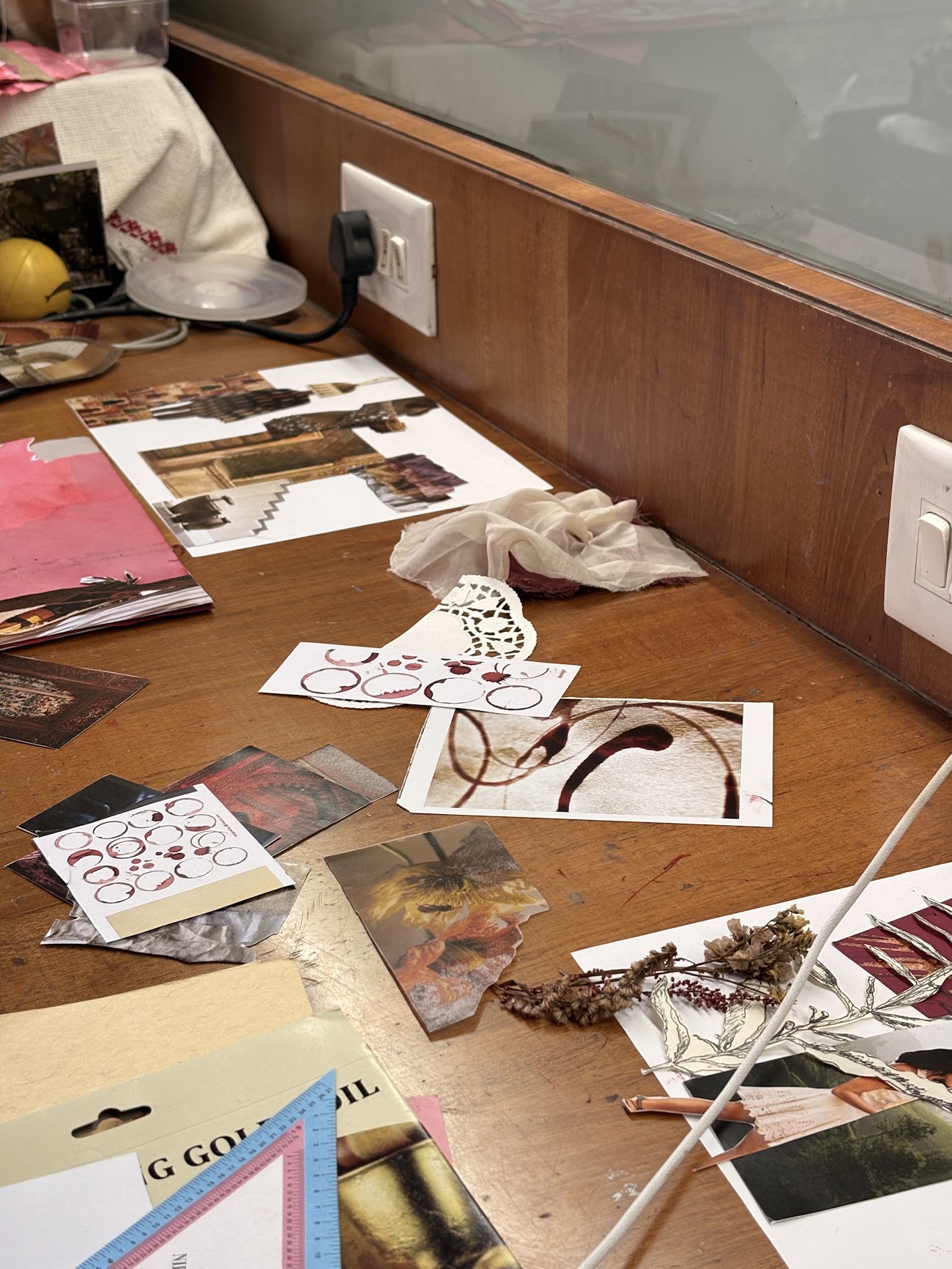 Parrie's working desk covered with references, samples and sketches