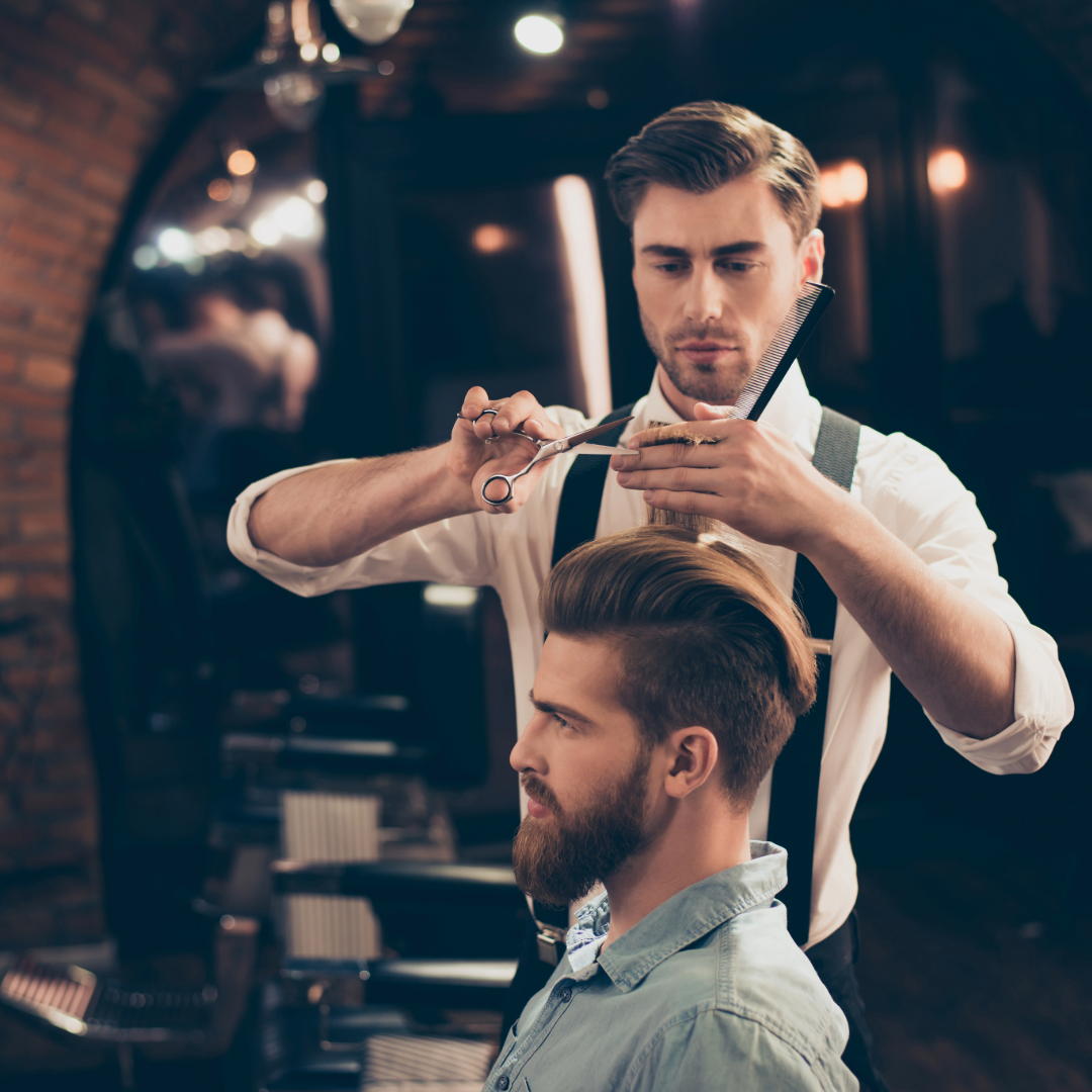 Barber styling hair at MR. CUT