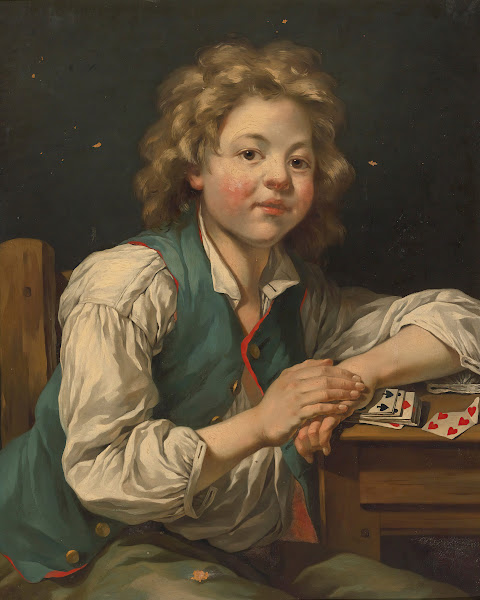 A Boy Seated Beside Atable With Cards