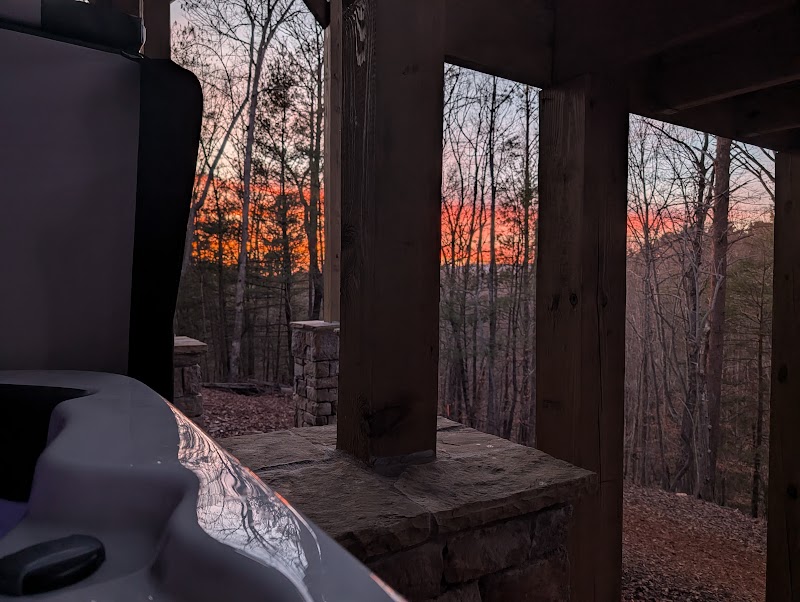 Sunset over the Blue Ridge Mountains seen from the hot tub at Orchard & Vine Mountain Haus in Ellijay, Georgia