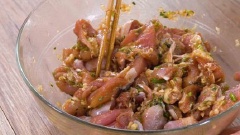 Sả băm nhỏ. Rau mùi, tỏi, lá chanh băm nhỏ. Thịt gà rửa sạch, cắt nhỏ, ướp thịt với nước tương, dầu hào, nước mắm, dầu mè, một phần sả, ngò, tỏi, lá chanh rồi trộn đều lên. Để gà 1 giờ cho thấm. Lá dứa rửa sạch, để ráo, bọc thịt gà với lá dứa.