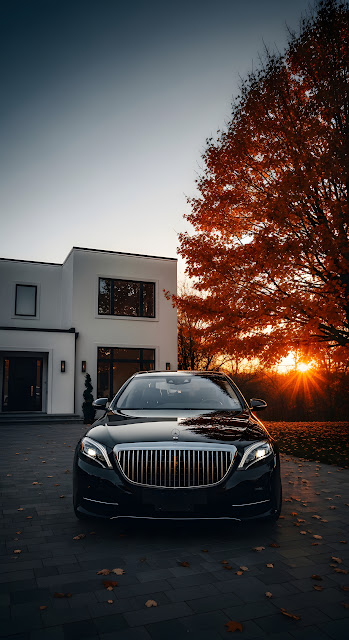 Black Luxury Sedan Parked Outside a Modern Home During Golden Hour Autumn - Free mobile Wallpaper