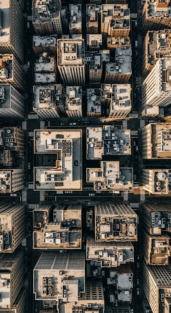 Dense Aerial View of New York City Building Rooftops and Street Grid Pattern - Free mobile Wallpaper