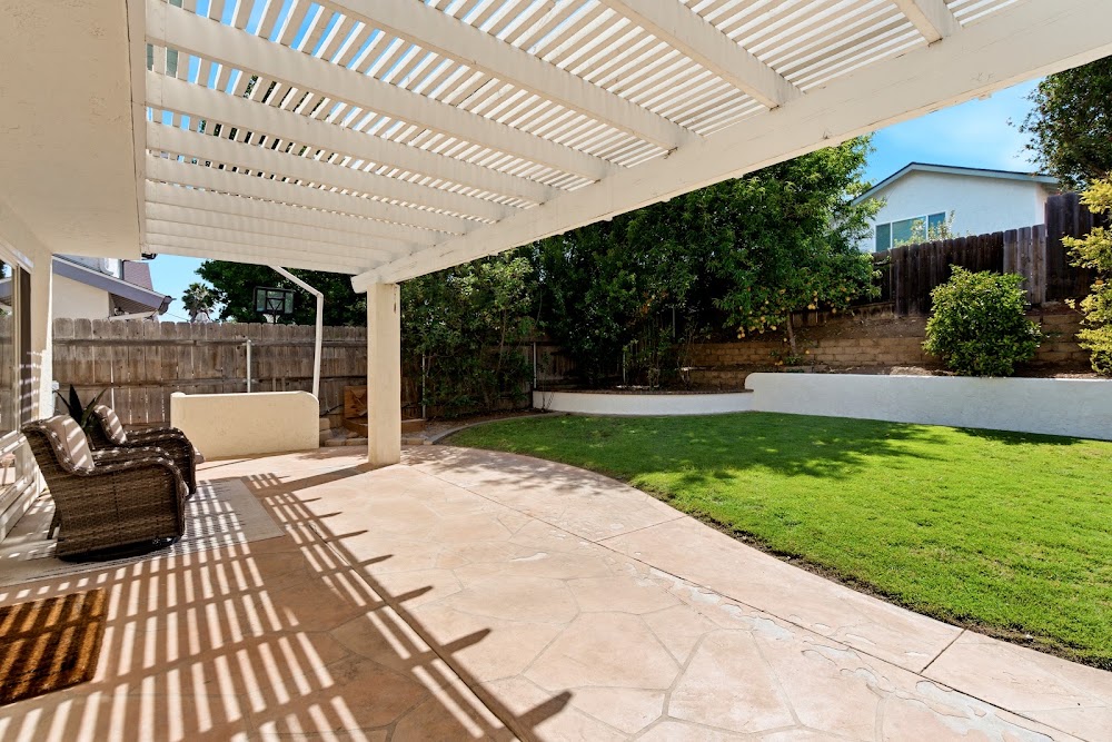 Backyard patio with fruit trees and BBQ