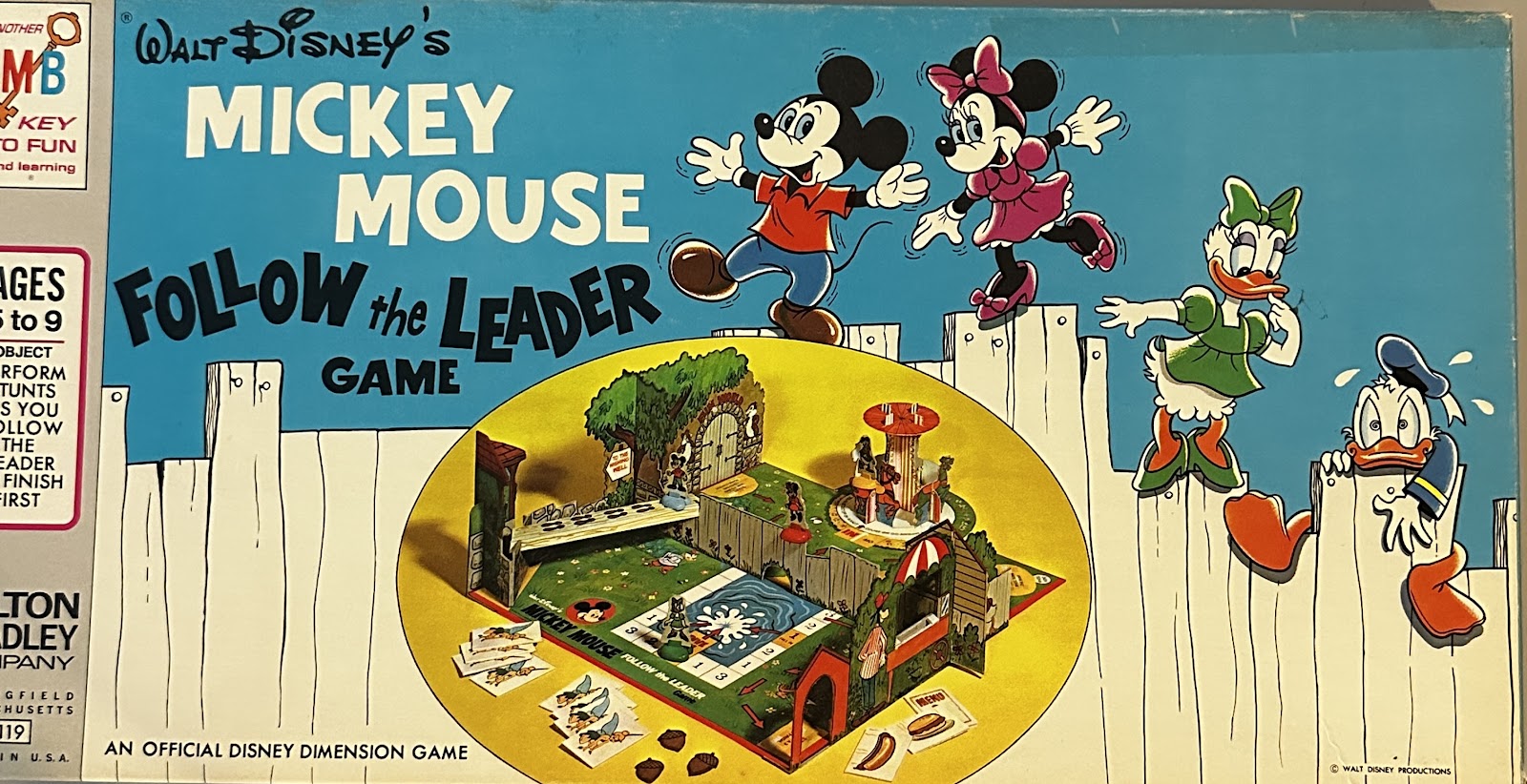 Walt Disney's Mickey Mouse Follow the Leader Game by Milton Bradley, with Mickey, Minnie, Donald, and Daisy walking a white picket fence above a 3-D backyard scene