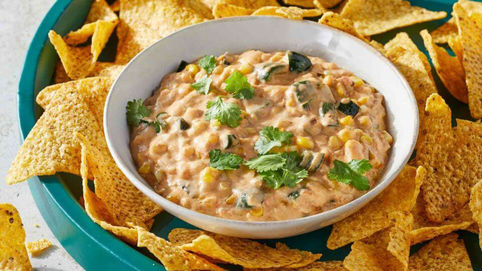 Cheesy queso dip made with cheddar cheese powder and served with chips.