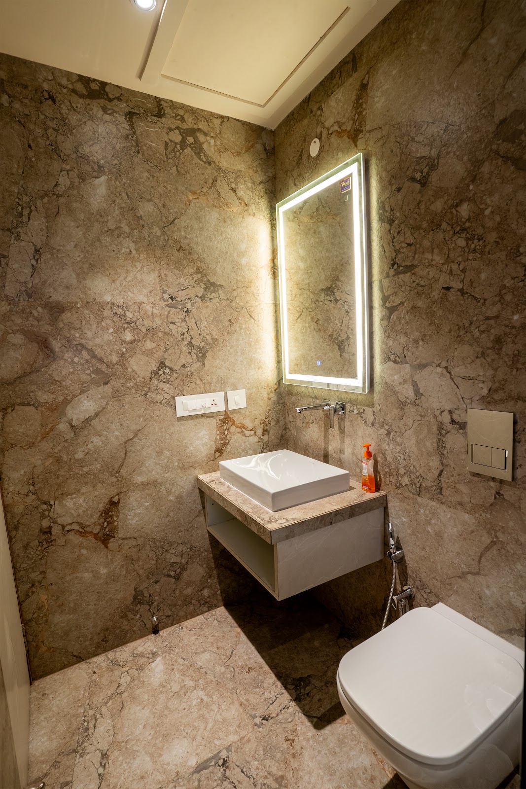 Marble ensuite bathroom with backlit mirror