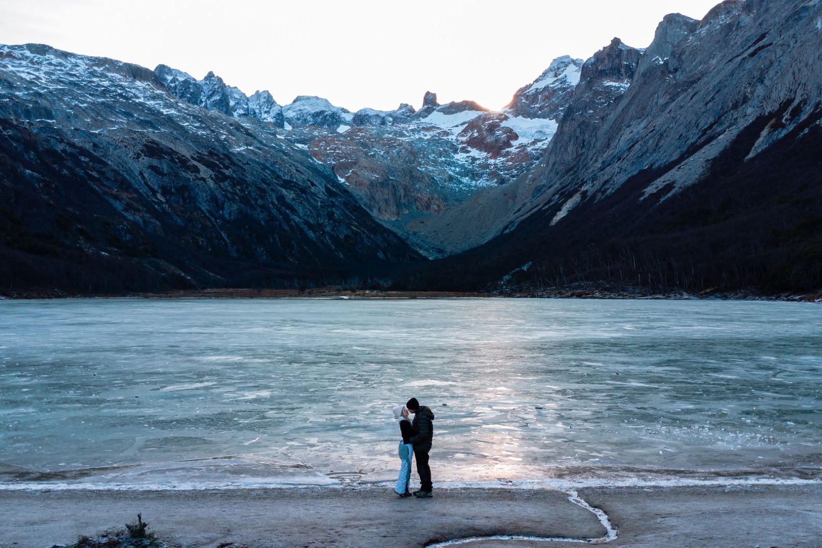 Couple overlooking a massive glacier and mountain landscape in Argentine Patagonia.