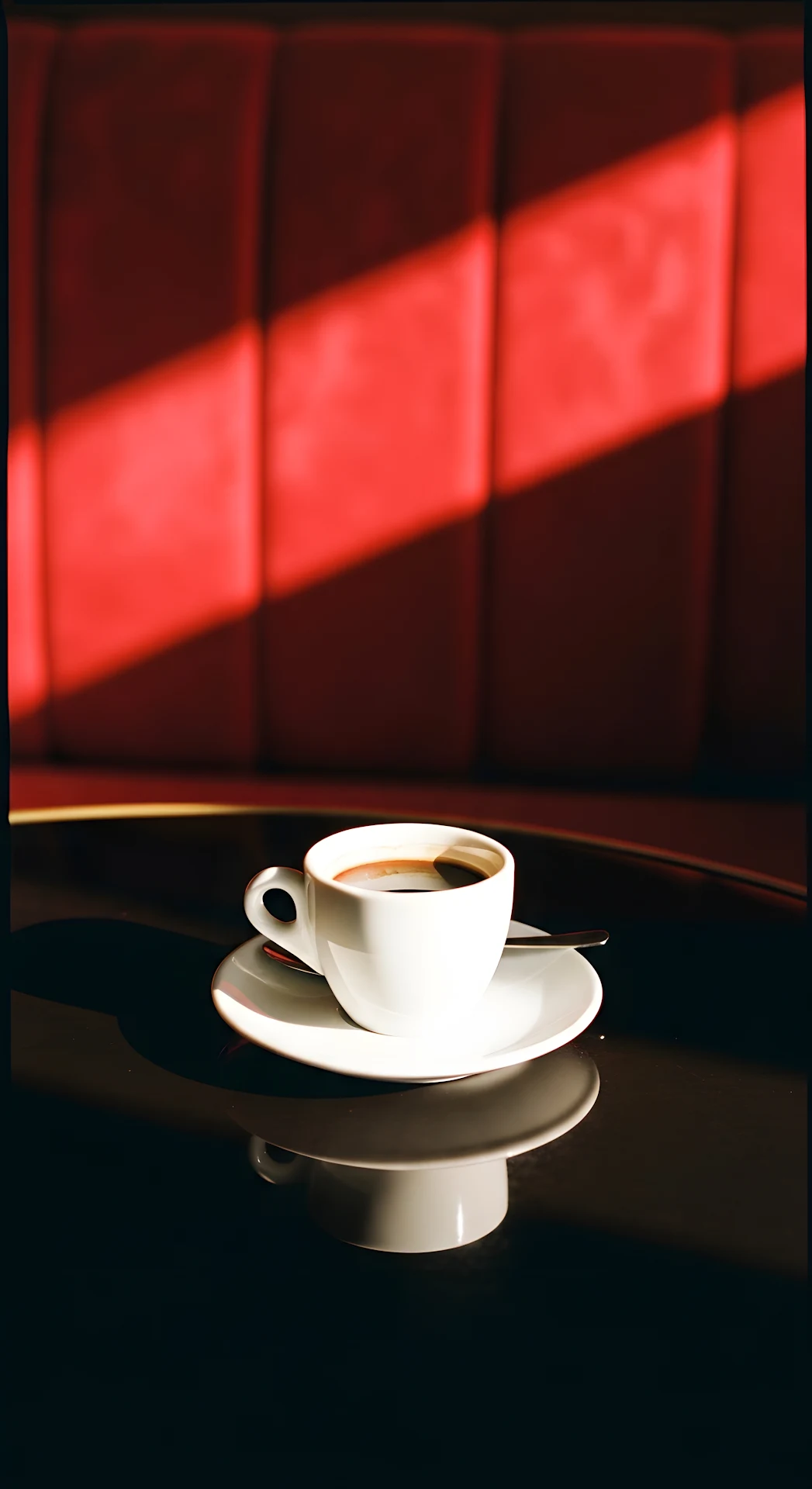 Cup of Coffee on Table with Reflection and Red Velvet Booth in Sunlight - Free 4K mobile Wallpaper