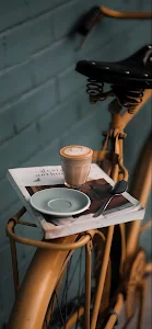 Latte Art Coffee and Book on Vintage Yellow Bicycle