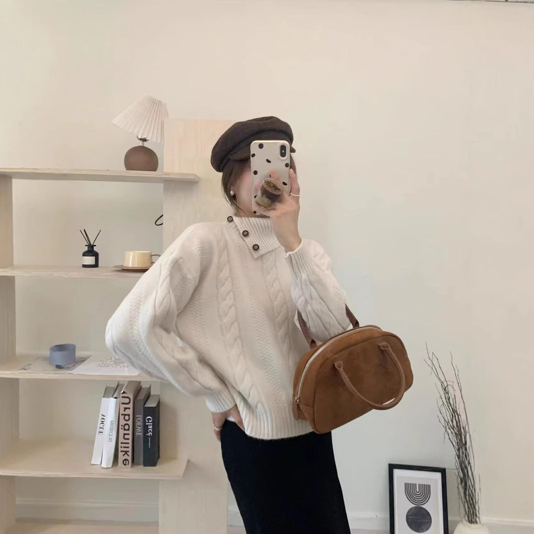 Short cable knit sweater with asymmetrical neckline