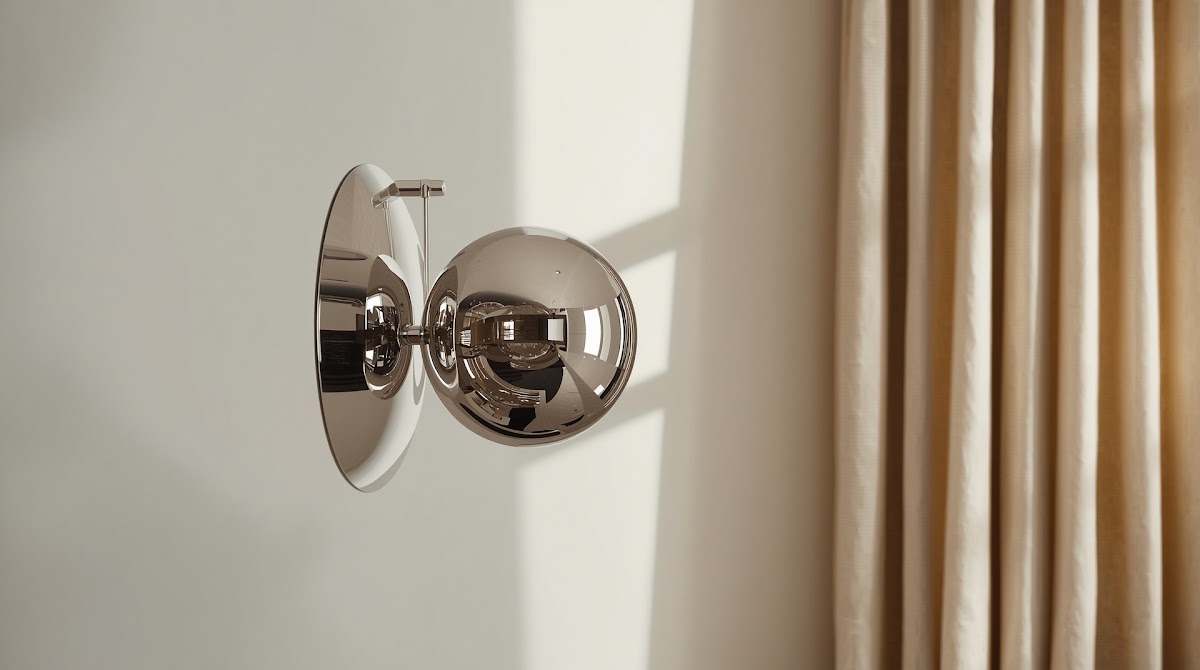 How to Fix the Most Common Chrome Decor Mistakes - sculptural chrome lamp with warm wood bookshelf and chair