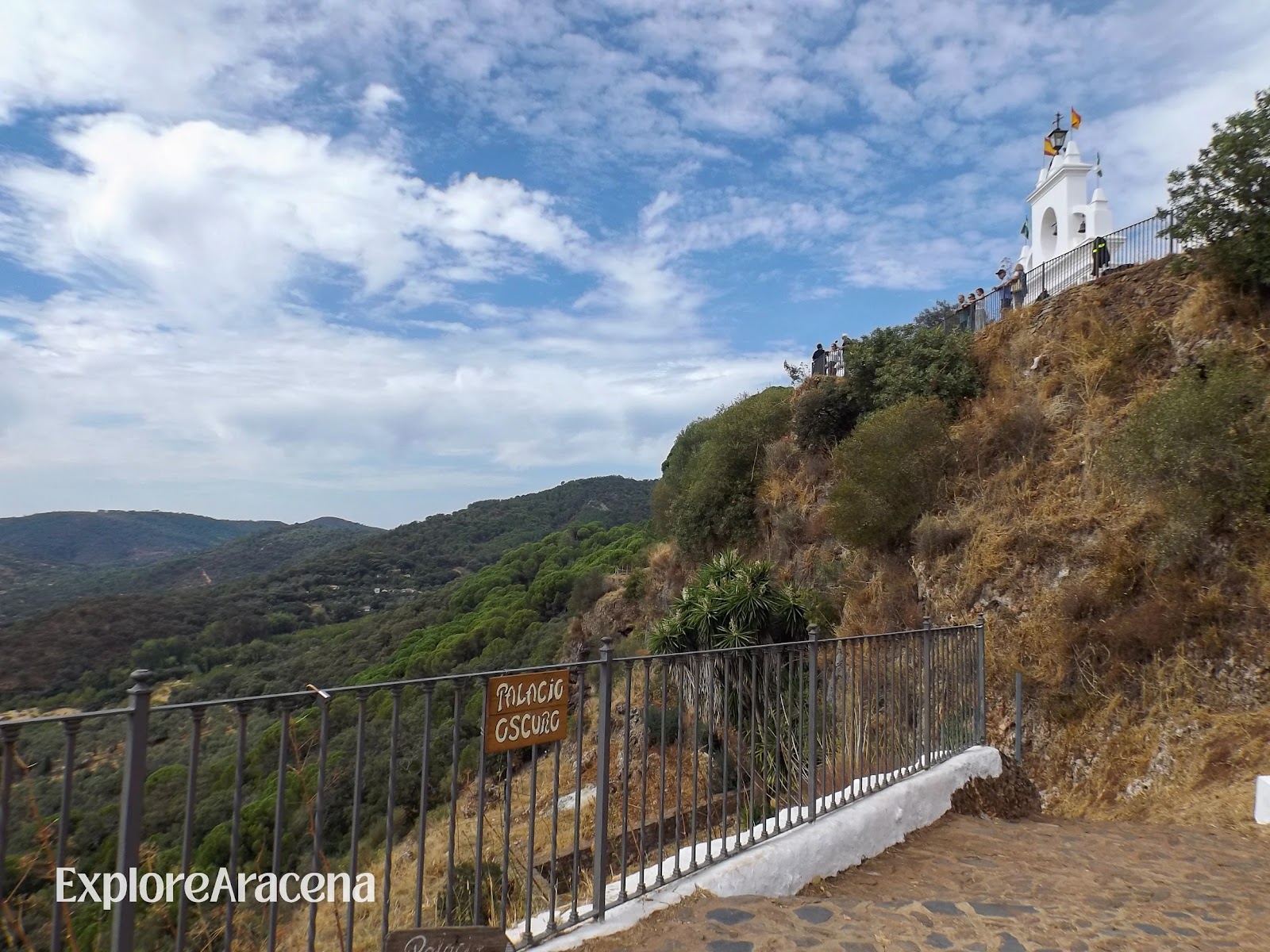 Whitewashed lookout structure above the wooded hills of the Sierra de Aracena, seen from the Peña de Arias Montano.