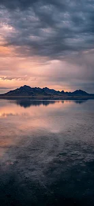 Vast Salt Flats Landscape at Dusk with Storm Clouds