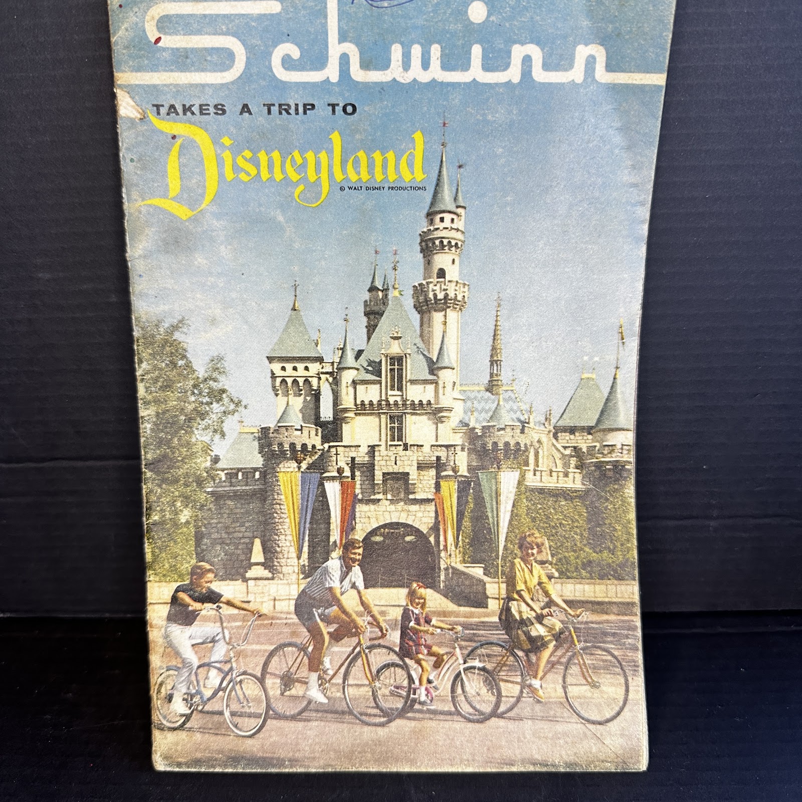 Vintage Schwinn Disneyland promotional booklet circa 1958–1965 showing a family with bicycles, Walt Disney Productions copyright on glossy cover