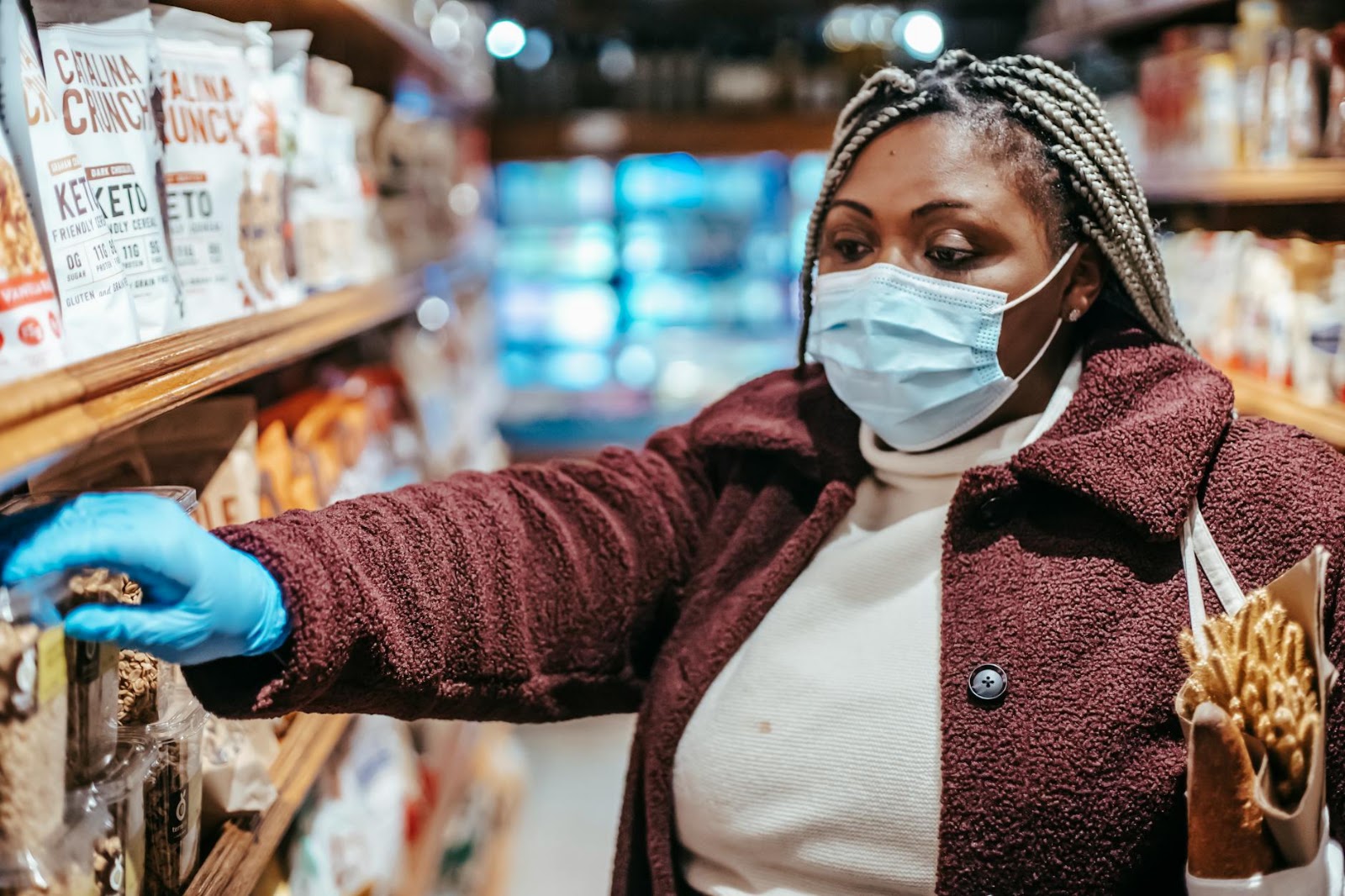 A robot hand selecting various shopping items, representing the generative AI market impact on retail and consumer choices.