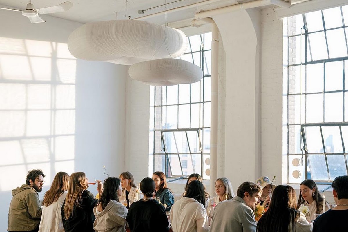 Team at a planning offsite around a long table in a loft