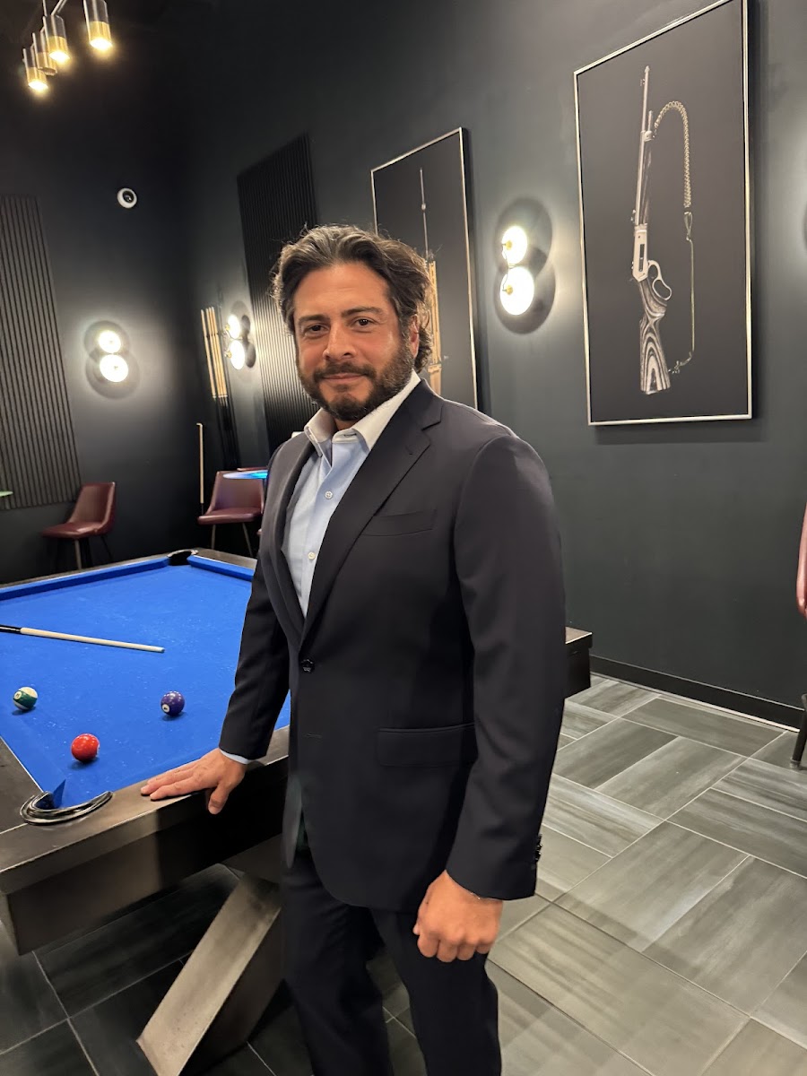 Grey bespoke suit with burgundy tie and pocket square in the Bespoke By CB showroom — expert color coordination for cocktail attire