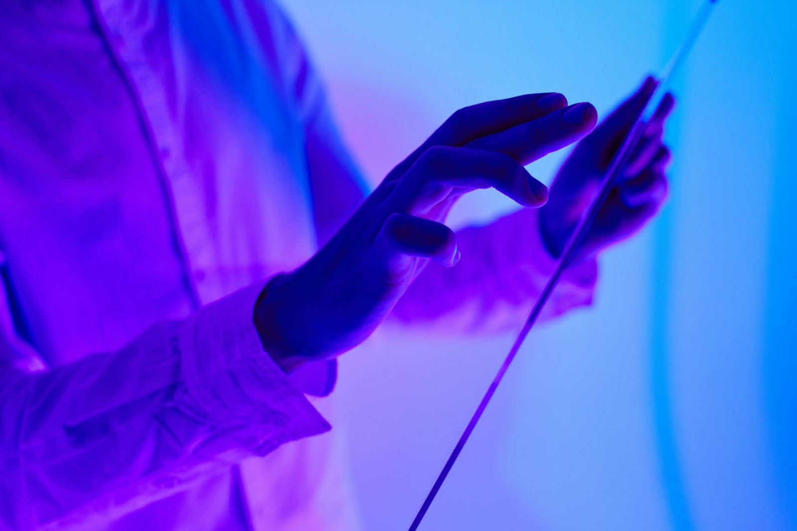 Hands interacting with a holographic interface displaying future live social media shopping trends and products.