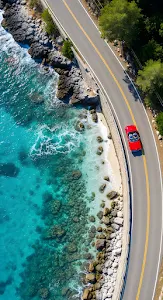 Red Convertible Driving Coastal Road Above Turquoise Ocean