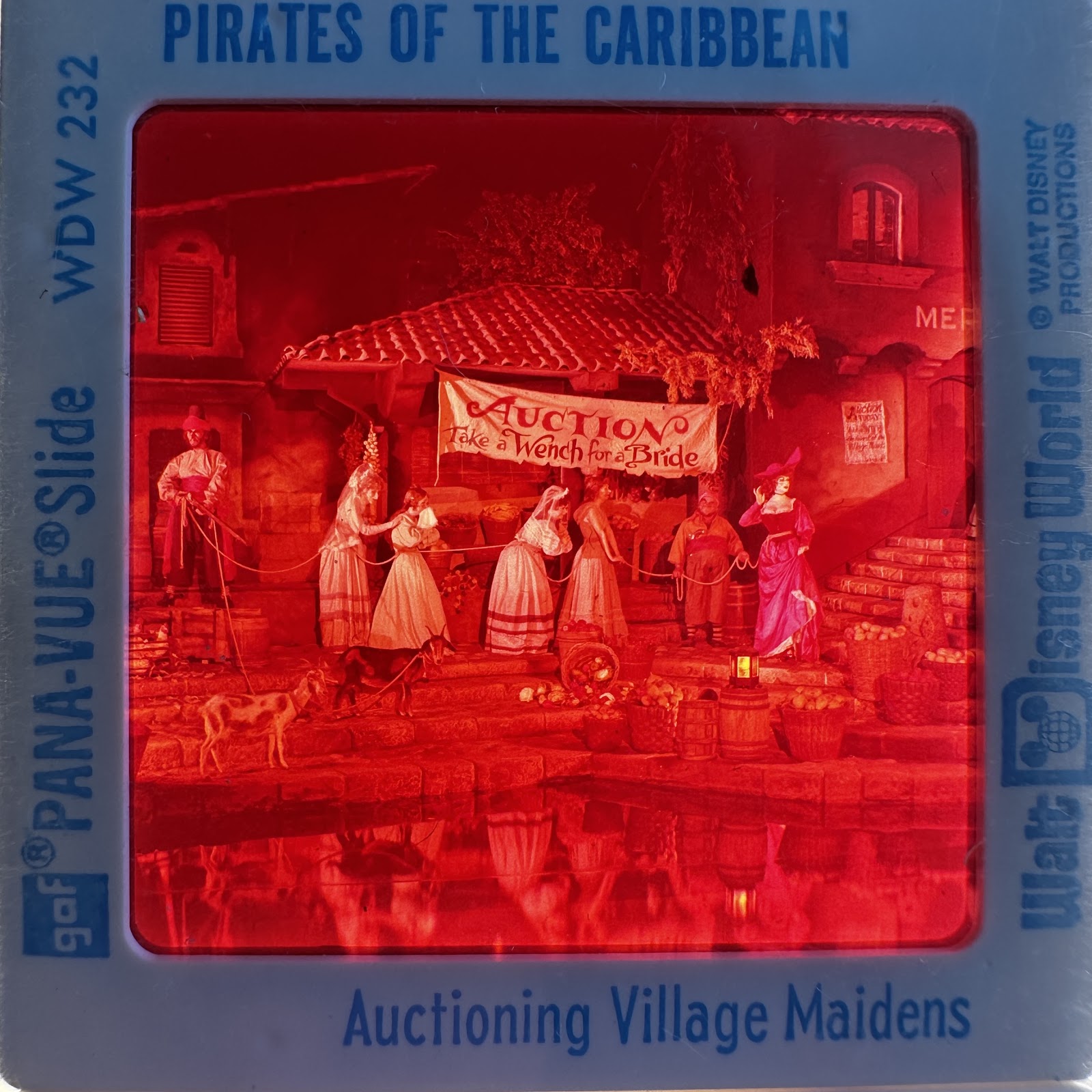 GAF Pana-Vue 2x2 slide WDW 232 showing Pirates of the Caribbean original auction scene with Auctioneer, Redhead, and village women, circa 1973–1986