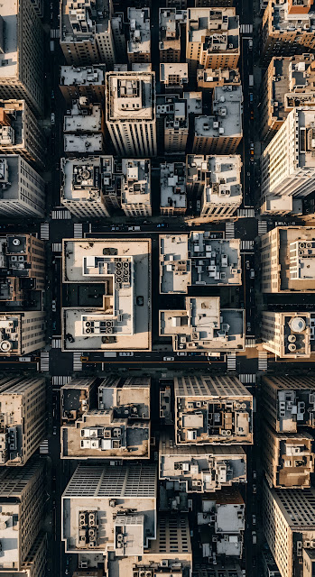 Dense Aerial View of New York City Building Rooftops and Street Grid Pattern - Free mobile Wallpaper