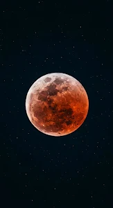 Blood Moon Lunar Eclipse Against Starry Night Sky