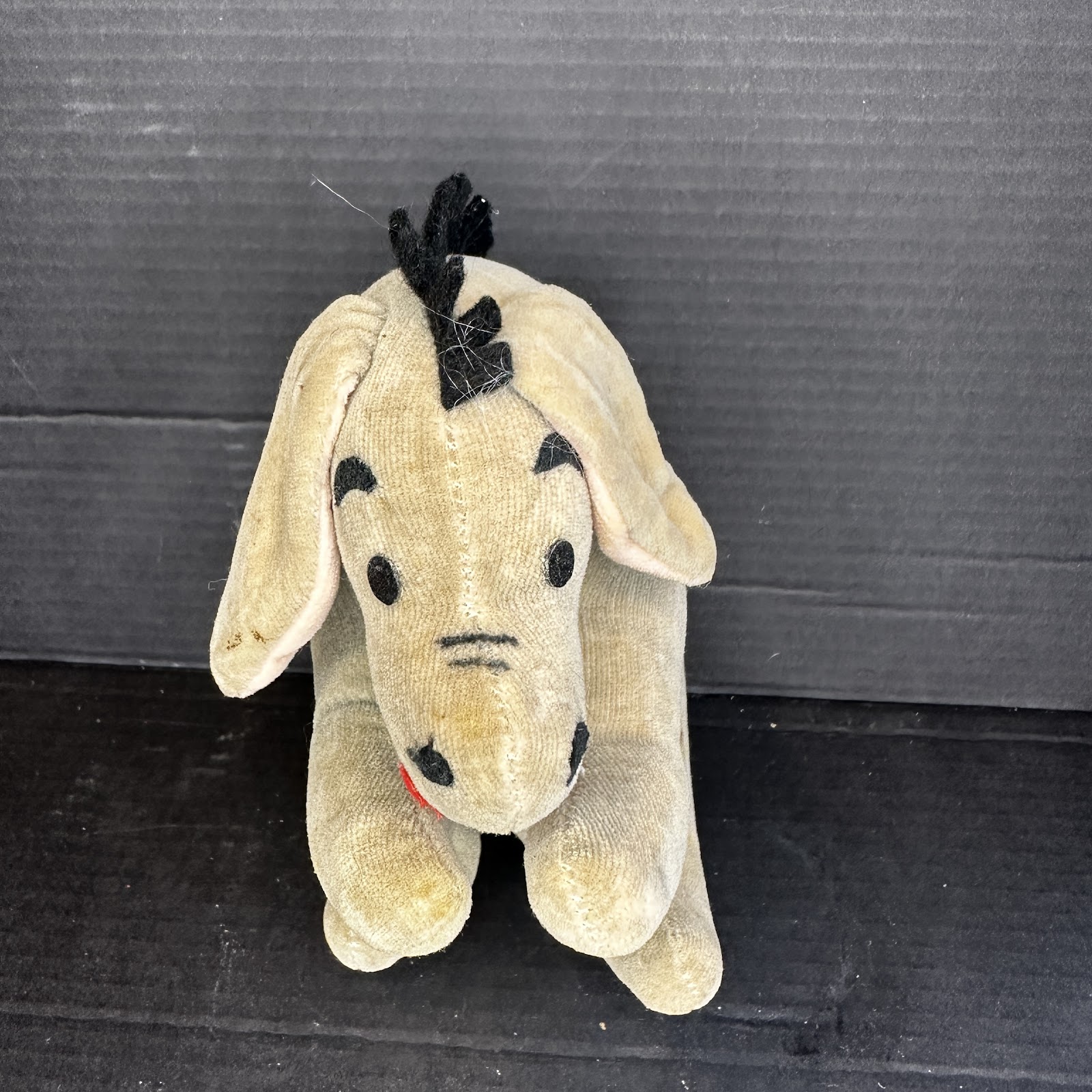 Vintage grey Eeyore plush toy with faded fabric, circa 1990, from the Winnie the Pooh Pooh Craze era