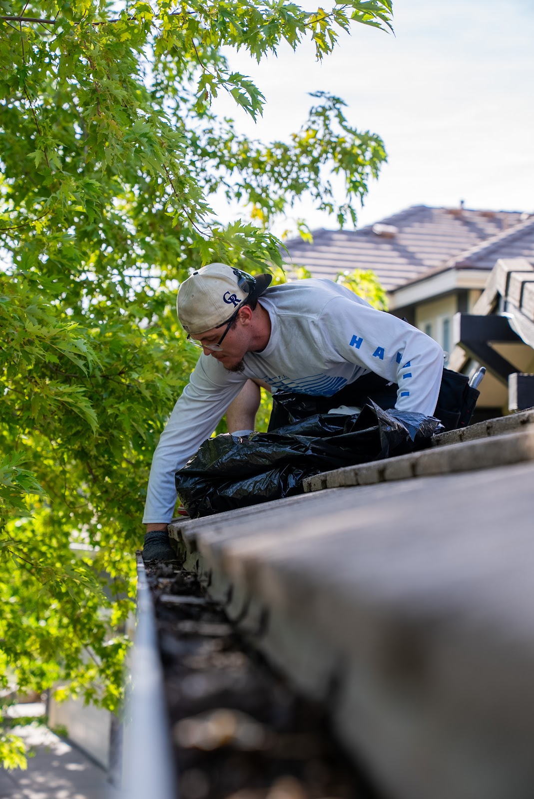 Gutter cleaning on residential roof