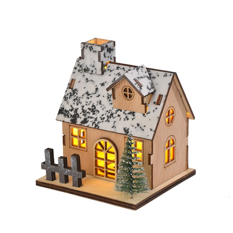Illuminated wooden house for Christmas table decoration