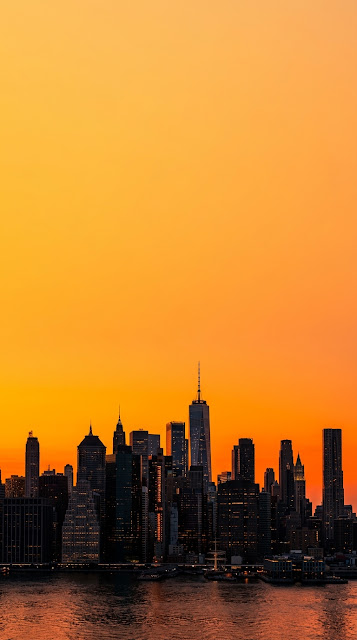 Dramatic Orange Sunset Silhouette over New York City Skyline - Free mobile Wallpaper