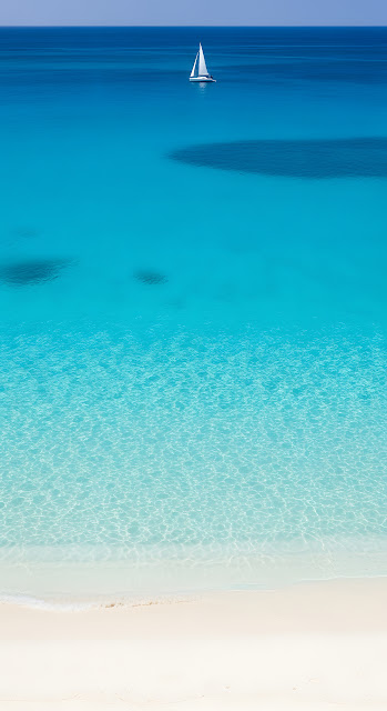 Minimalist Sailboat on Azure Blue Ocean Near White Sand Tropical Beach - Free mobile Wallpaper