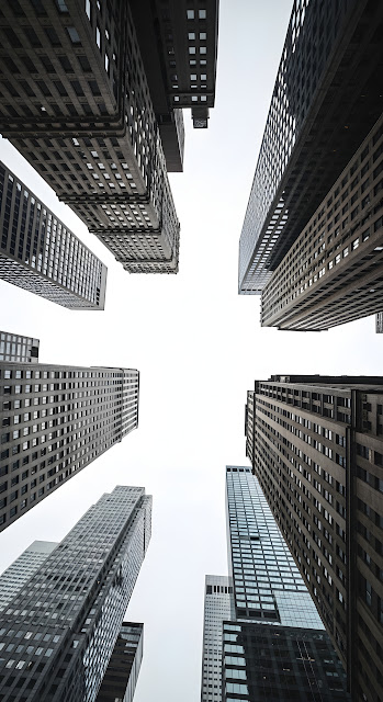 Low Angle View of Converging Dark Skyscraper Facades - Free mobile Wallpaper
