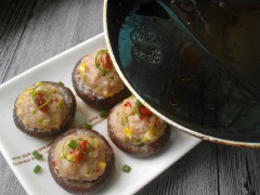Cho dĩa thịt viên nhồi nấm vào nồi hấp. Hấp trong thời gian 15 phút. Thịt viên nhồi nấm chín, mang ra ngoài, chắt phần nước ra nồi nhỏ, nêm nếm ti dầu mè, và xíu tiêu cho thơm. Mang nước sốt rưới lên trên nấm.