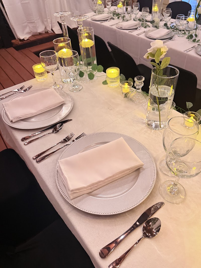 White place settings with rose and floating candle centerpieces