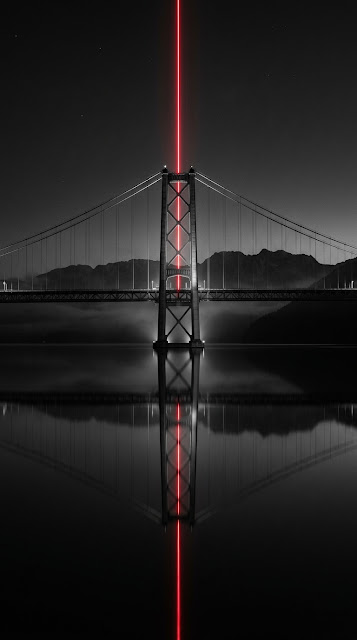 Long Exposure of a Bridge with a Sharp Red Light Beam and Water Reflection - Free mobile Wallpaper