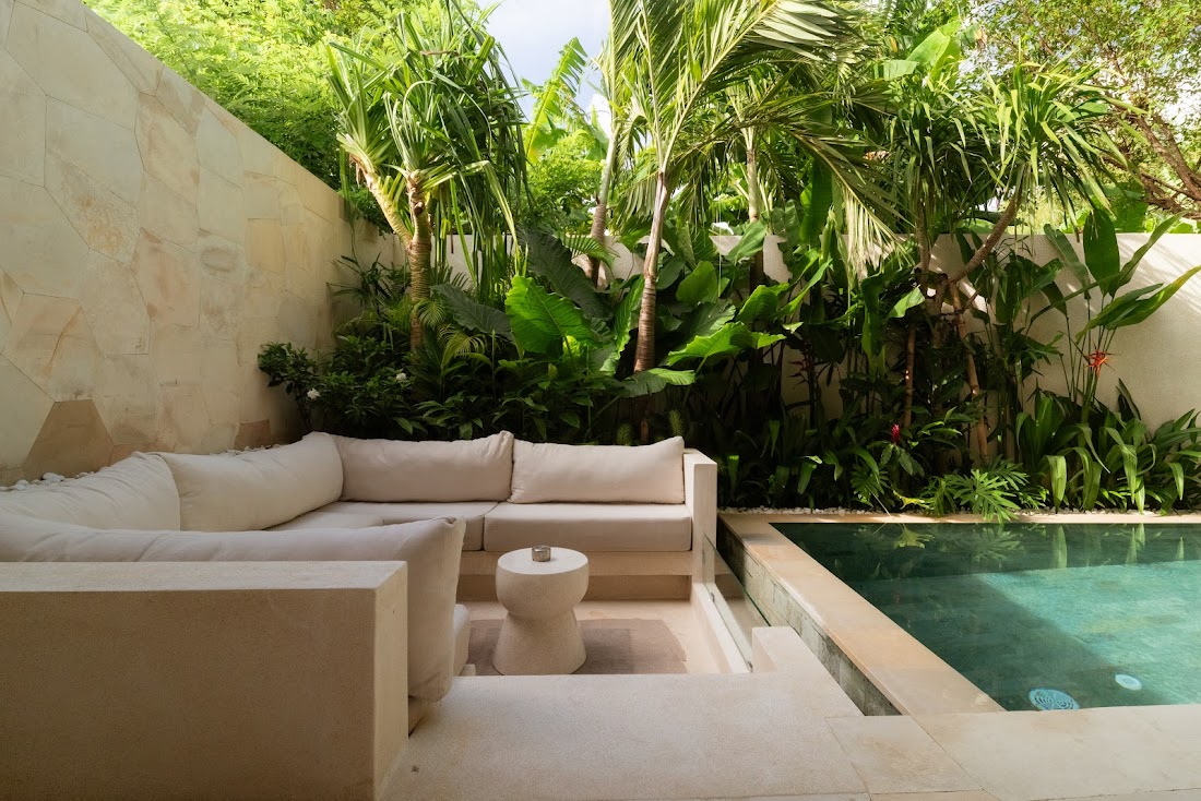 Calm sunken lounge opening to greenery at La Calma villa in Uluwatu