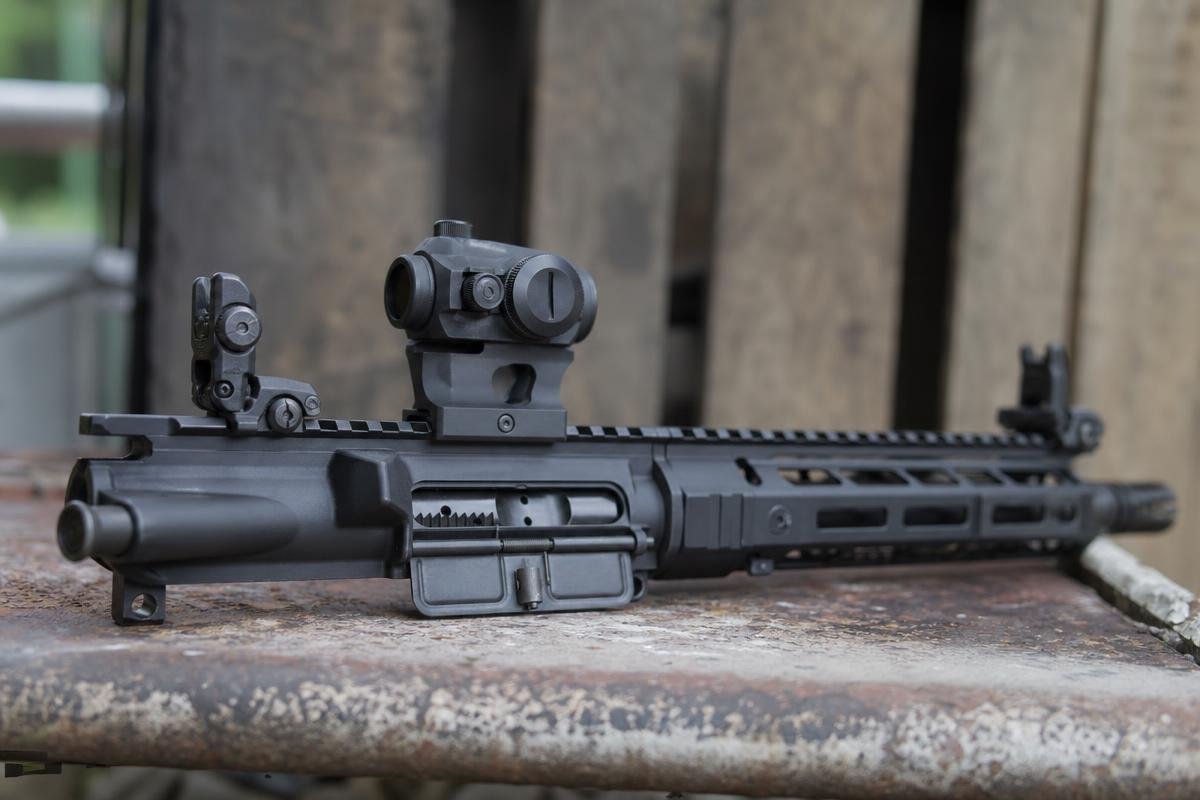 AR-15 backup sights setup with red dot and flip-up iron sights co-witnessed on flat-top rail